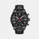 A TISSOT PRS 516 CHRONOGRAPH watch with a black band and black dial, featuring a perforated design on the bracelet and red accents on the watch hands.