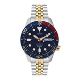 Watch with a blue dial and gold and silver band on a white background