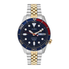 Watch with a blue dial and gold and silver band on a white background