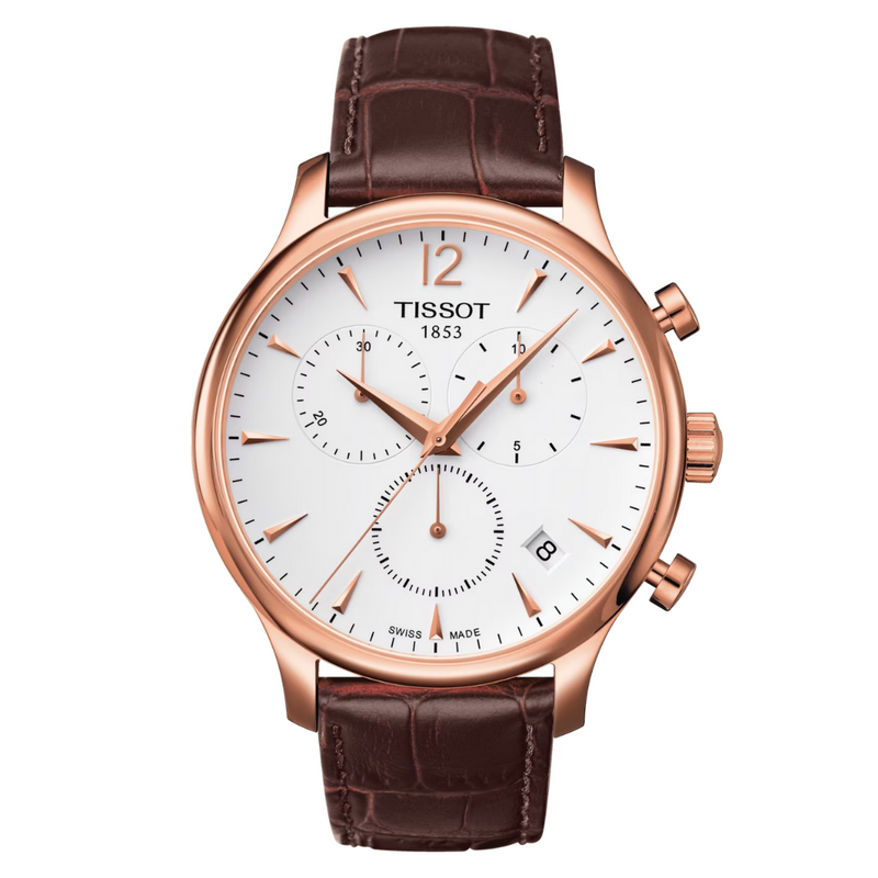 A TISSOT Tradition Chronograph watch with a white dial, rose gold case and bracelet, and a brown leather strap.