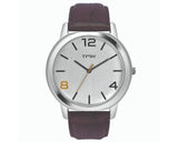 A silver-toned casual watch with a brown leather band and accent Arabic numerals and markers on the dial.